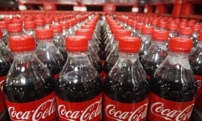 Lined up bottled coca-cola beverages