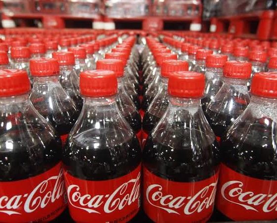 Lined up bottled coca-cola beverages